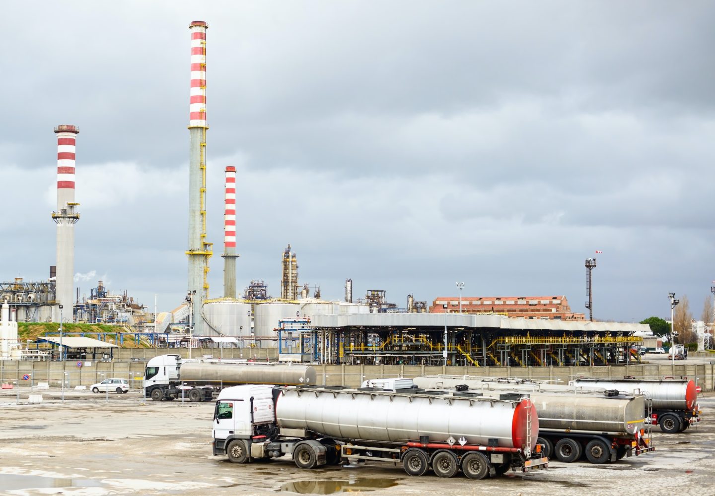 oil-refinery-industry-smoke-stacks-and-tanker-lorry-or-truck.jpg